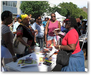 Mallette (red rhirt) speaks to fans and Harlem Book     Fair 2007