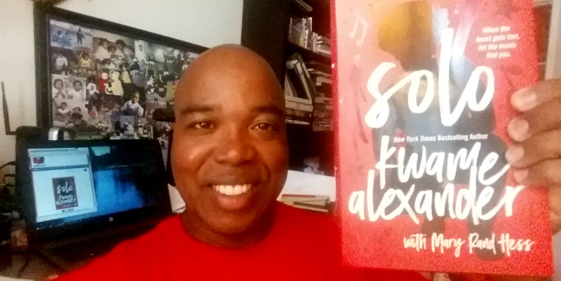 Kwame Alexander’s book Solo held by Troy Johnson