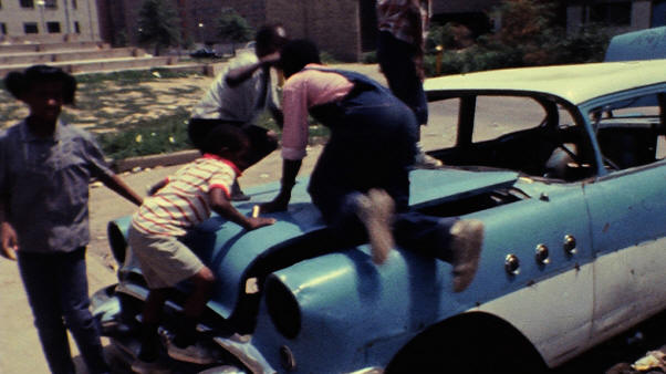 Kid playing on car at Pruitt-Igoe