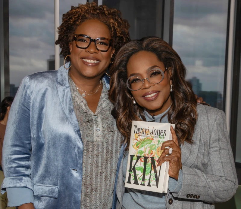 Photo of Tayari Jones with Oprah holding a copy of the book Kin