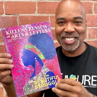 Photo AALBC Founder Troy Johnson with copy of the Fall / Winter issue of the Killens Review of Arts & Letters
