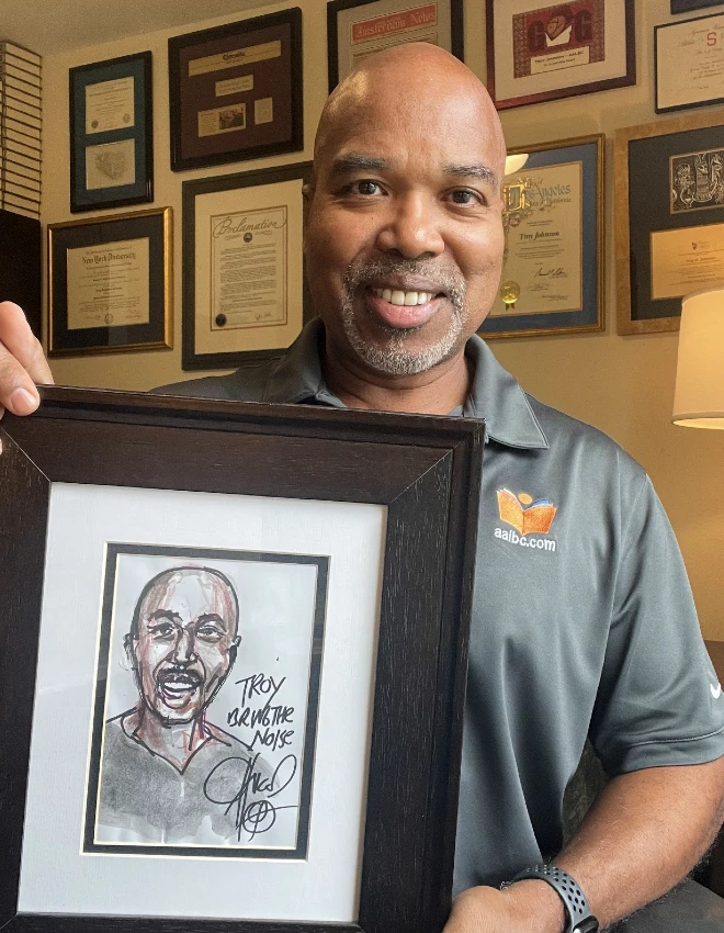 Troy Johnson with his original custom fine-art portrait drawn by Chuck D