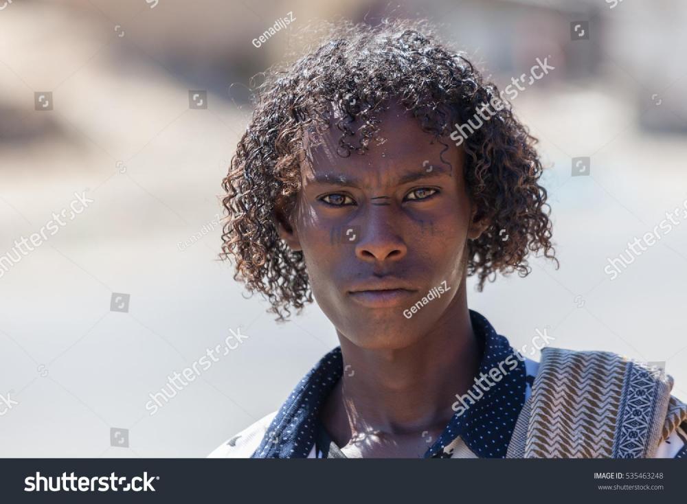 stock-photo-tigray-ethiopia-afar-tribe-man-with-curly-hair-and-facial-tattoos-535463248.jpg